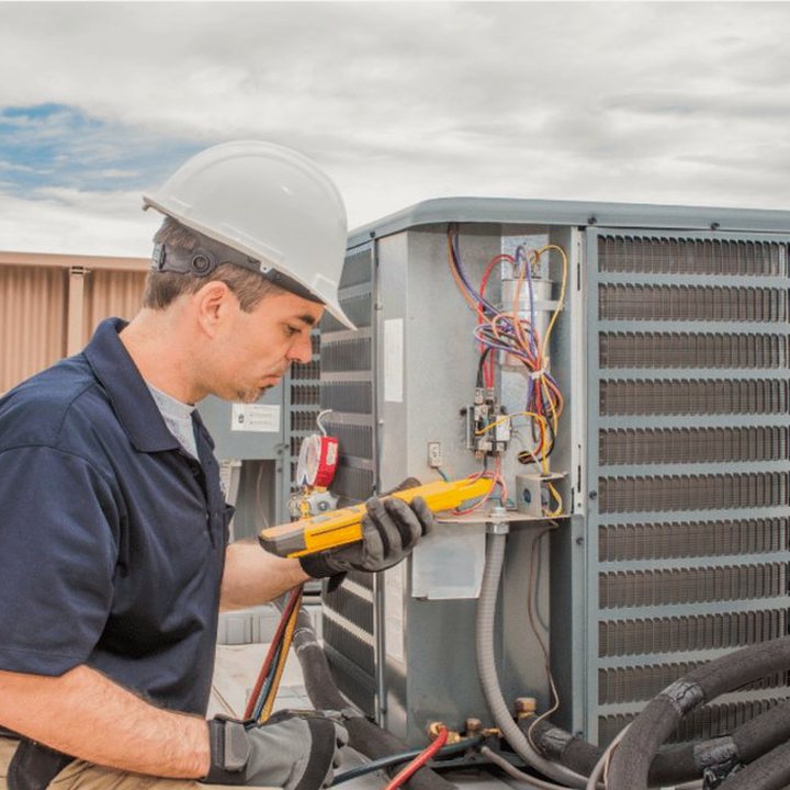 Exeter Heating & Cooling technician servicing a propane furnace on a rural Huron County property